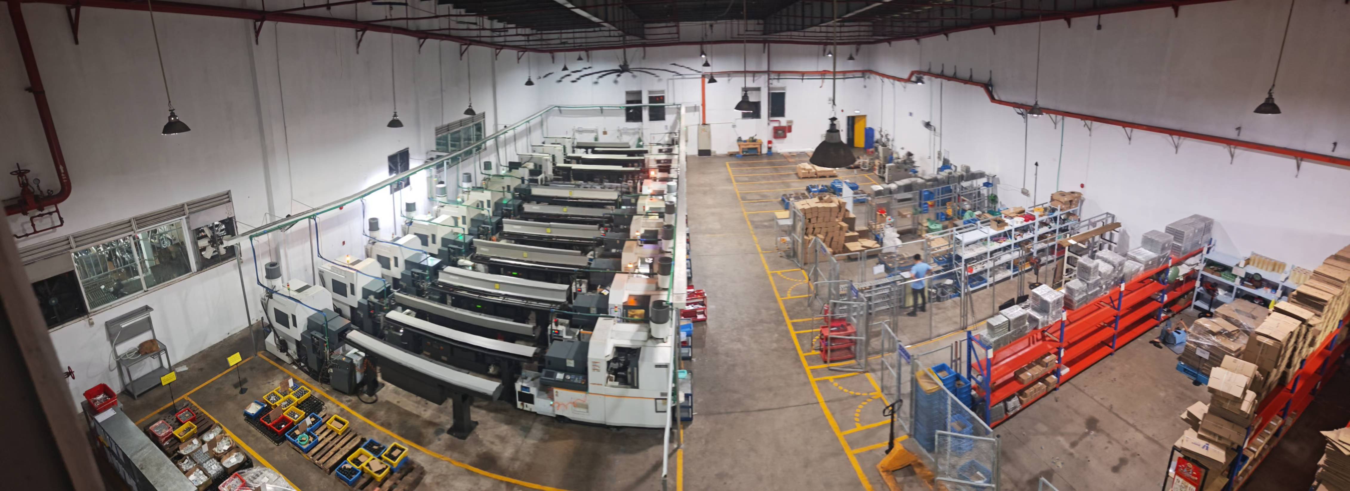 Aerial view inside the Chung Yuk workshop with rows of Swiss-type CNC lathes and organized storage areas